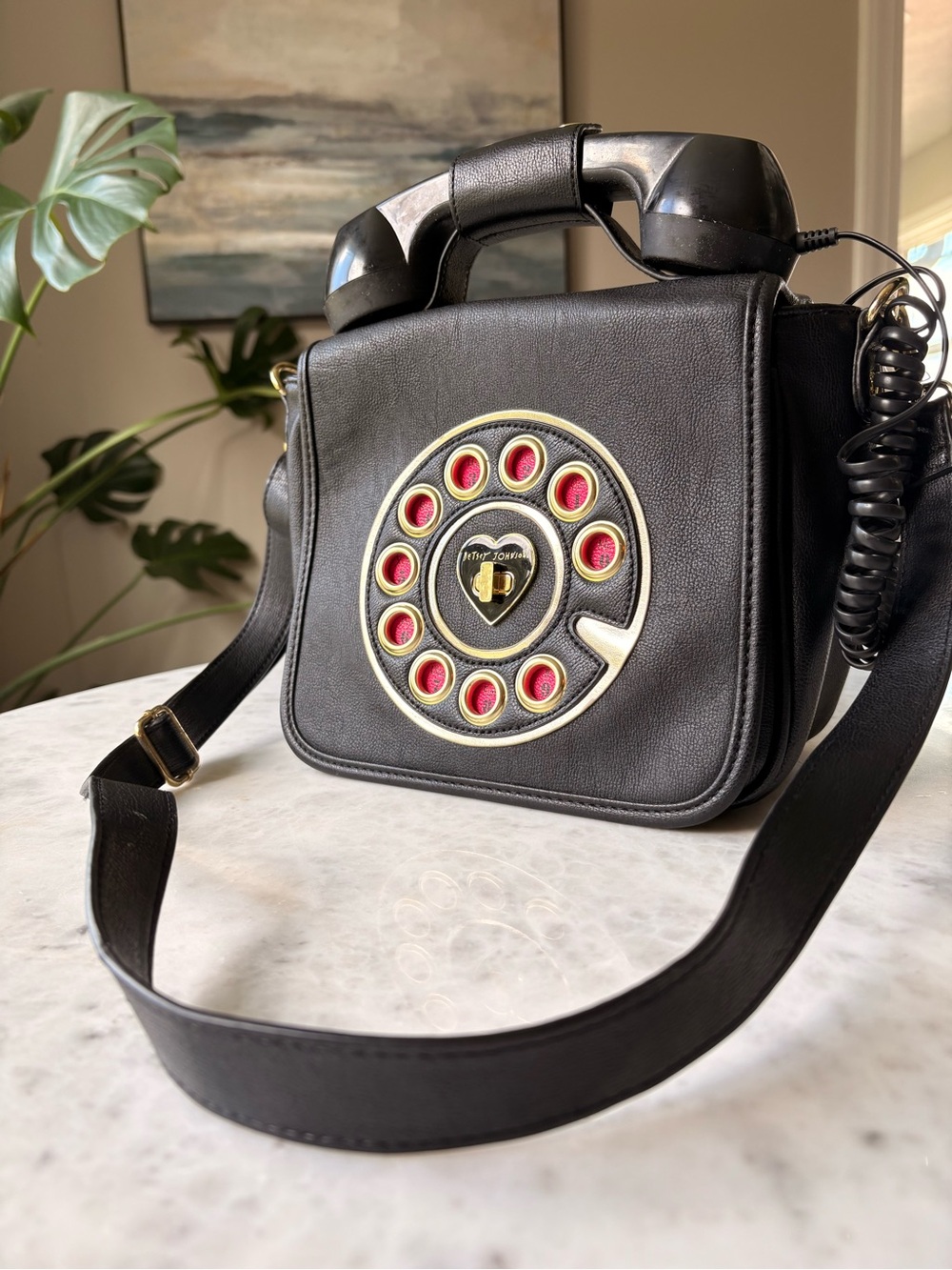 Rare Betsy Johnson black phone bag with pink and gold accents.